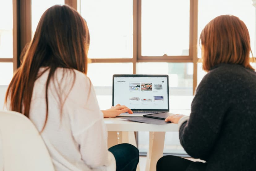 Two women looking at the laptop
