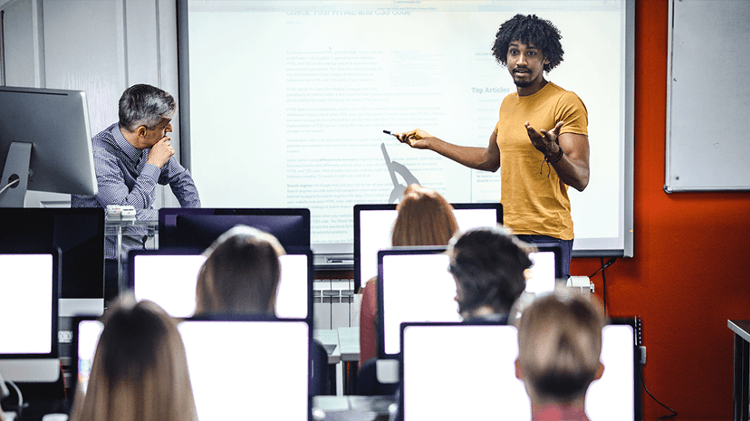 Person presenting in front of a college classroom