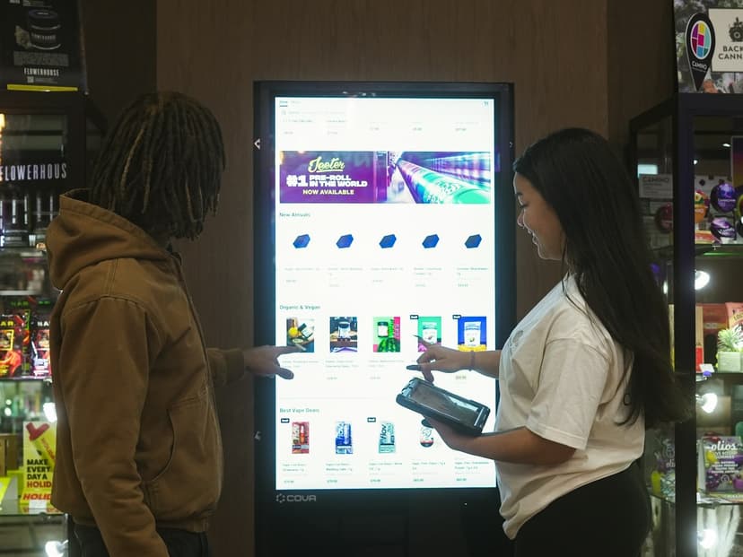 Interactive touchscreen kiosk with networked display showing product catalog in retail space